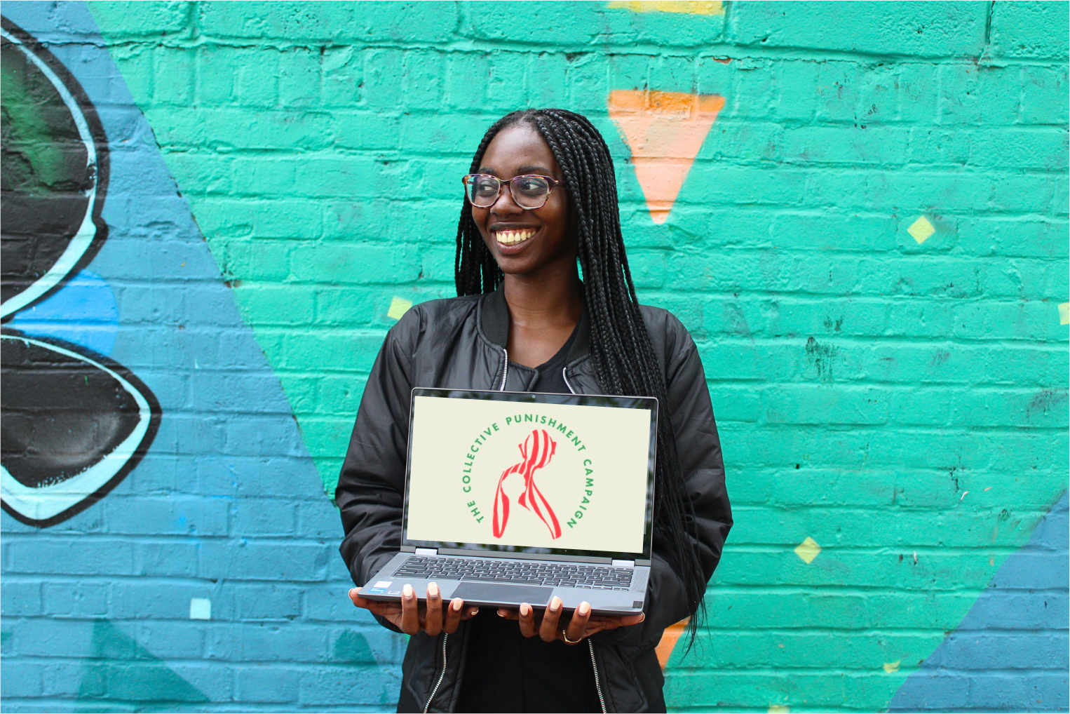 Jemma holding a computer reading The Collective Punishment Campaign logo