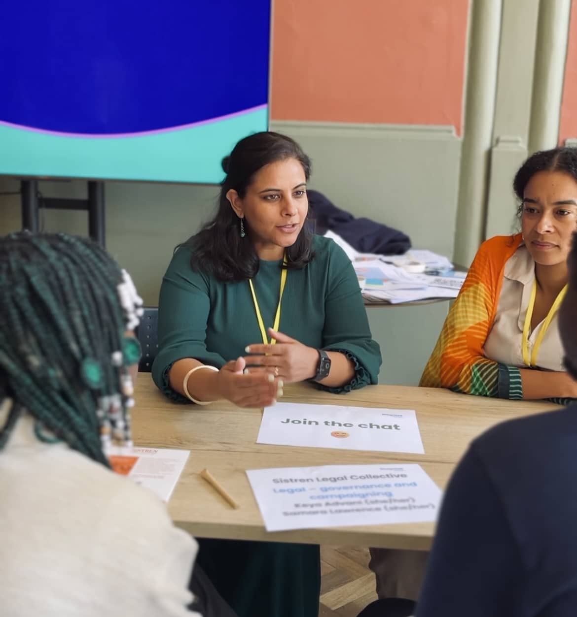 A women talking at a table with others