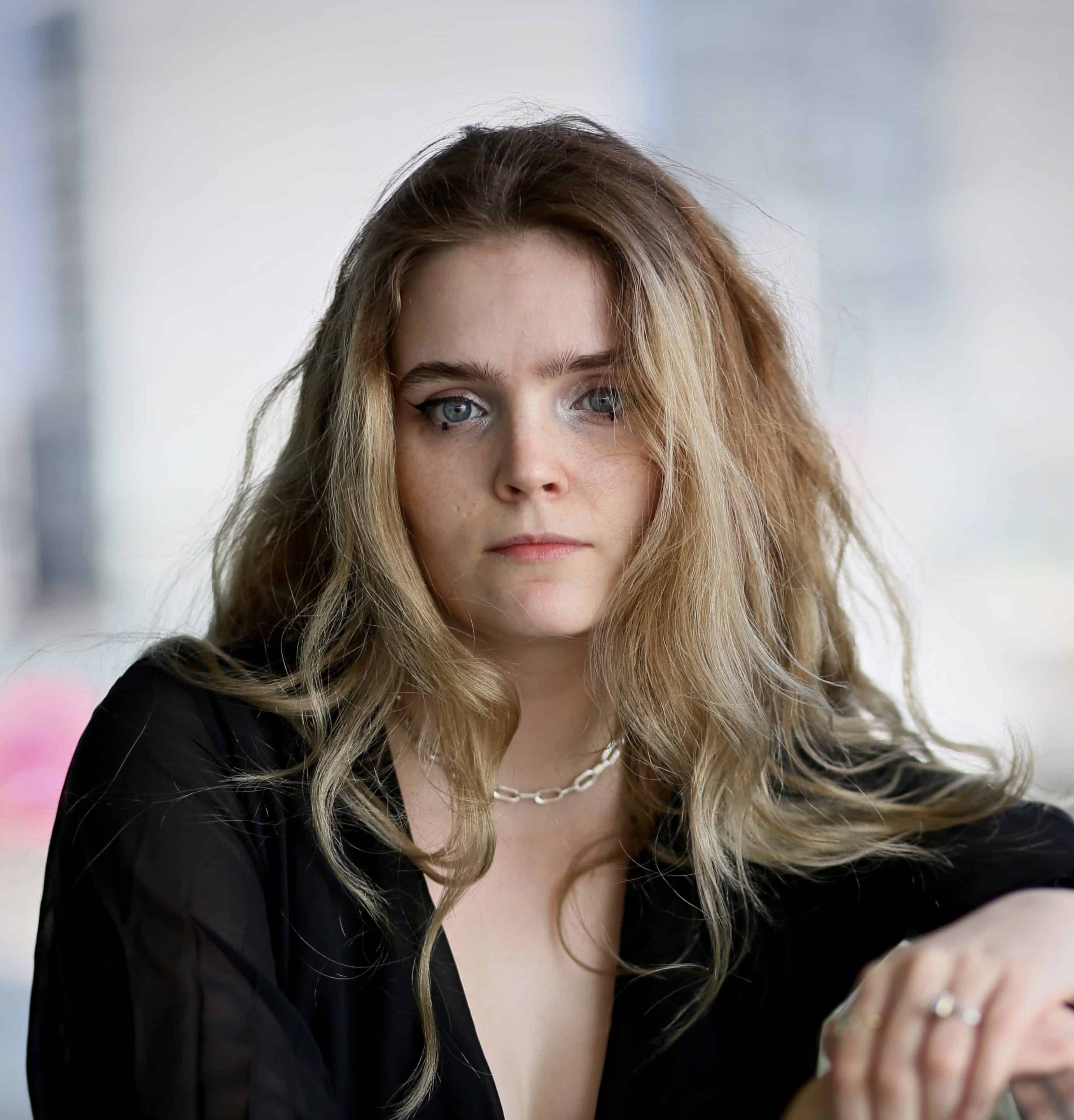 A portrait shot of a person looking at a camera 