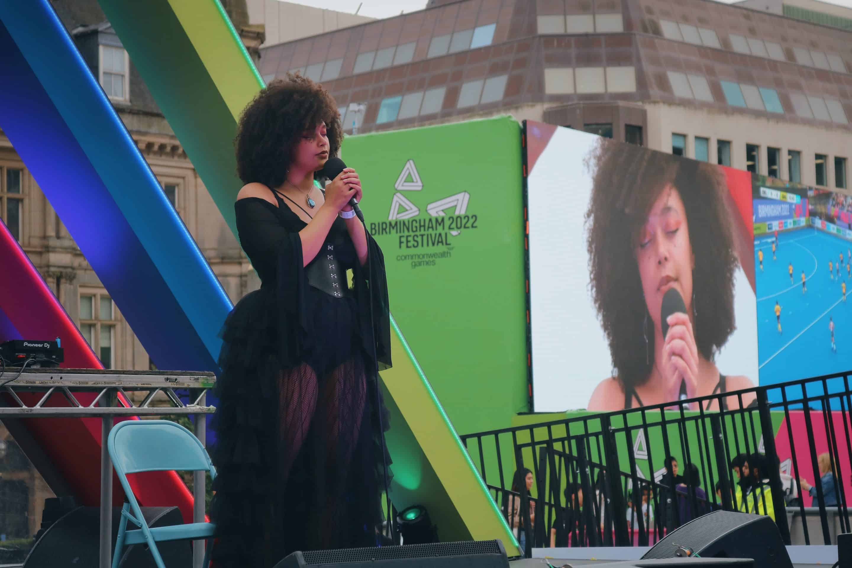 A person performing with a mic on stage