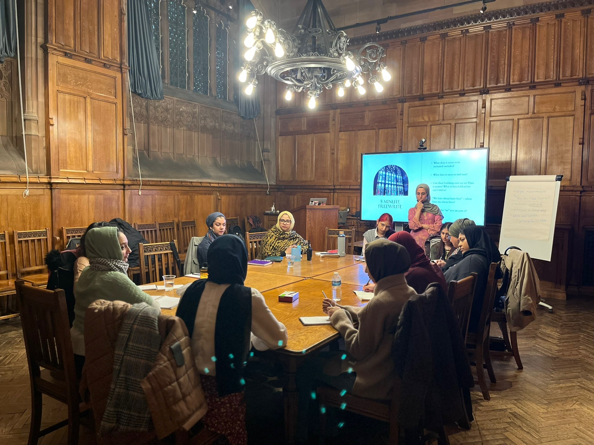 A group of women sitting together round a table in discussion
