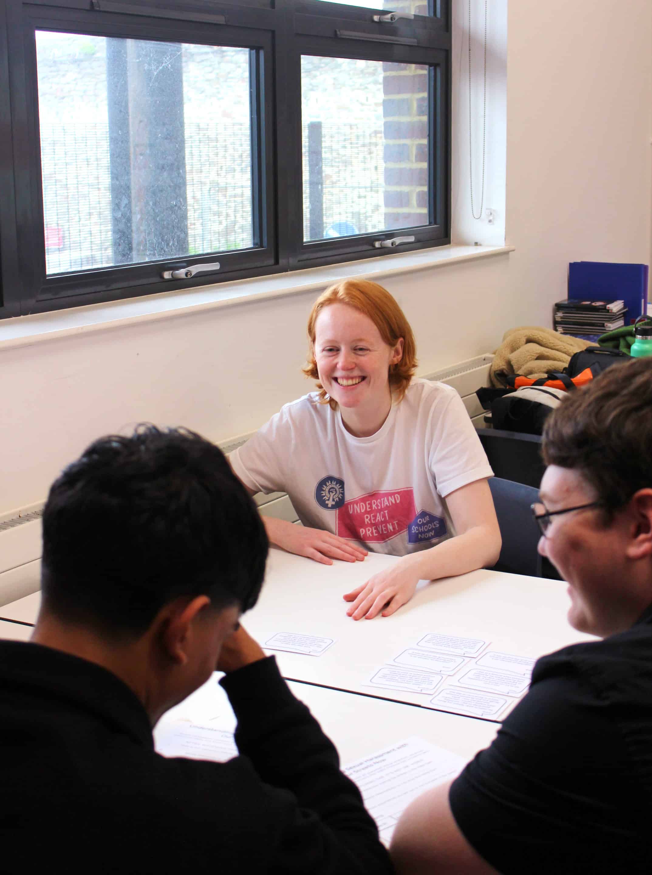 A women talking to others across a table