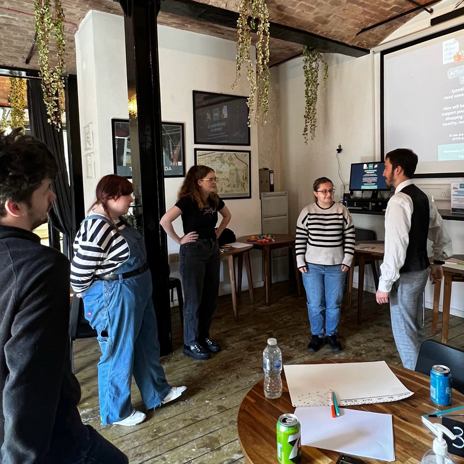 5 people standing up facing each other