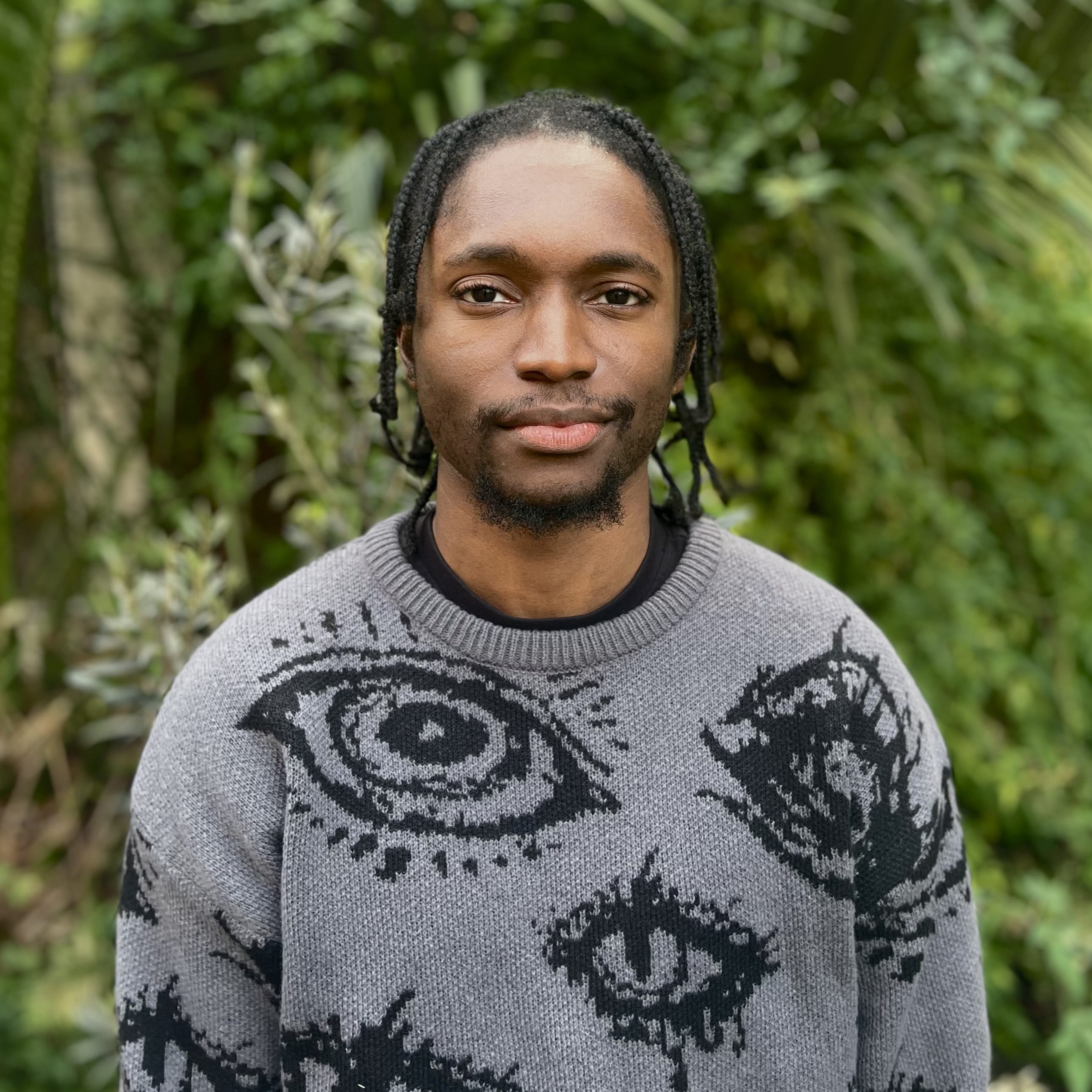A man in a grey jumper taking a picture